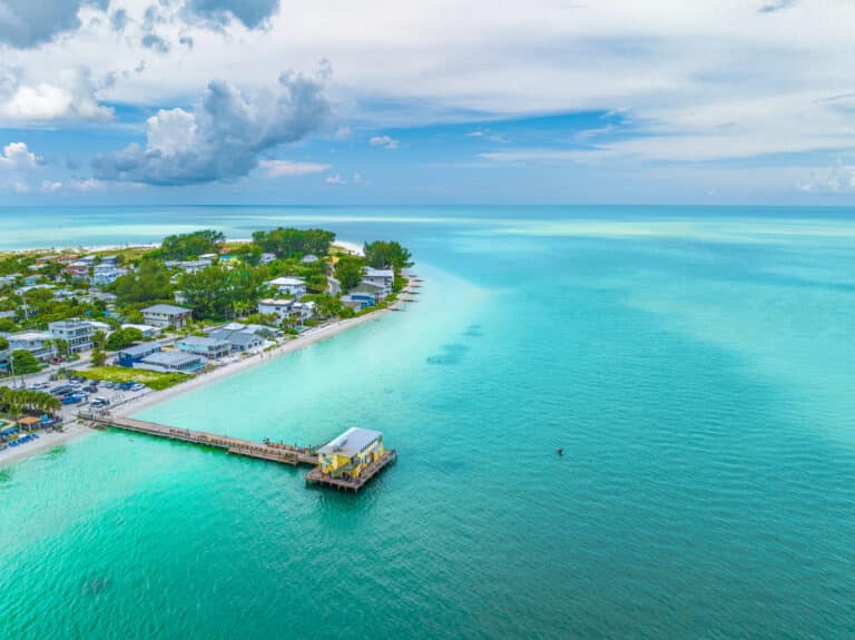 An aerial view of a fishing pier on Holmes Beach in Anna Maria Island Florida