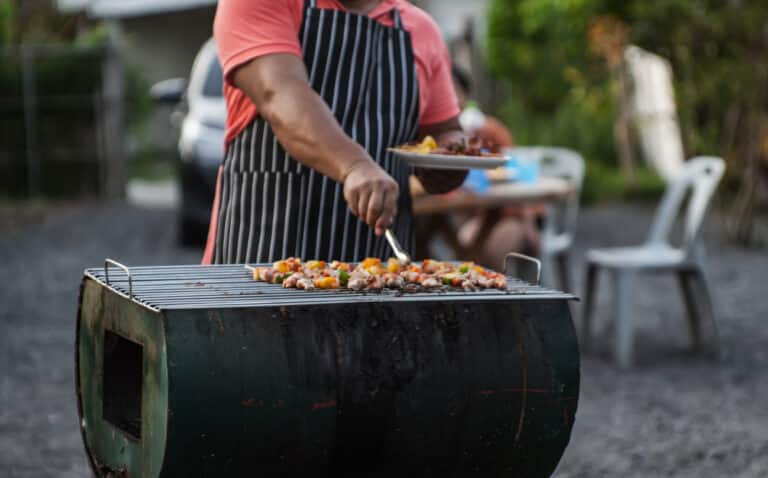 Man on a grill, barbecuing for friends