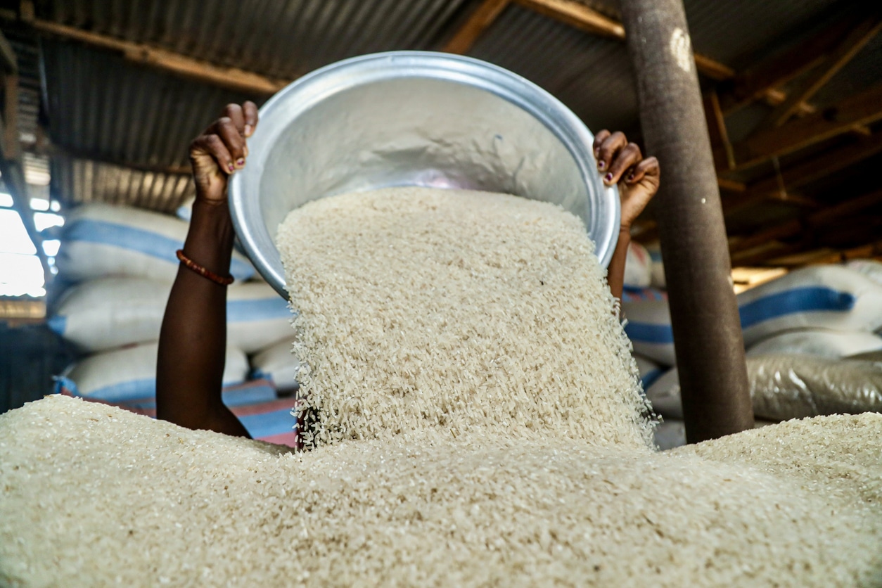 An African woman processing rice