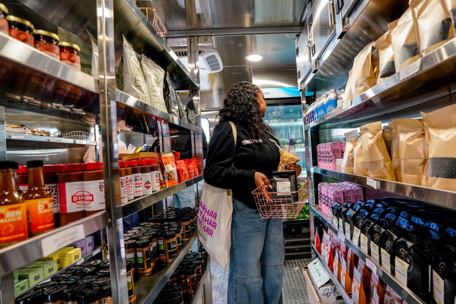 Community member shopping inside Prosperity Market's mobile food trailer